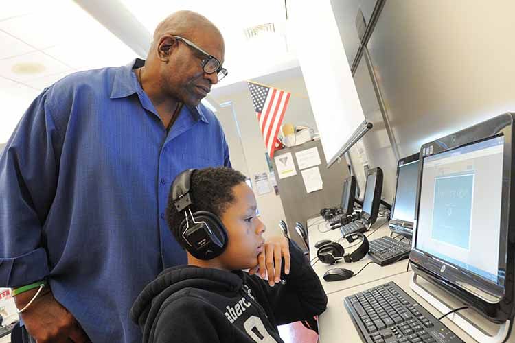 teacher and student at computer